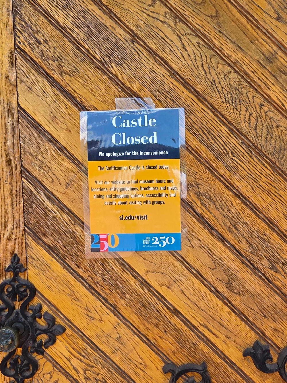 A sign saying the Smithsonian Castle in Washington, D.C., is temporarily closed (John Bowden / The Independent)