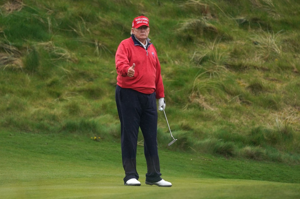 Donald Trump playing golf at Trump International Golf Links & Hotel in Doonbeg, Co Clare, during his visit to Ireland in 2023 (Brian Lawless/PA) (PA Archive)