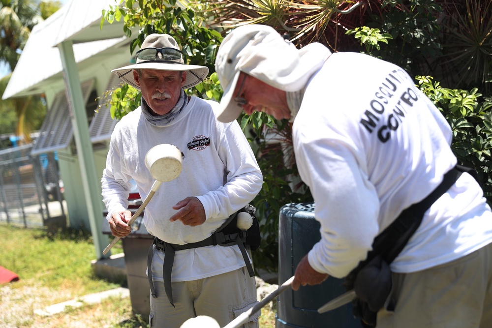 Florida mosquito control workers inspect a neighborhood for mosquitoes carrying dengue in Key Largo, Florida, in July 2020. Wearing long-sleeved clothing and long pants helps protect people from potentially dangerous mosquito bites (Getty)