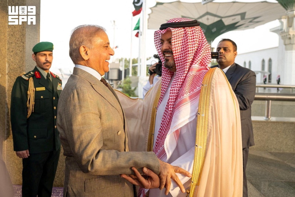 Pakistan's Prime Minister Shehbaz Sharif is received by Deputy Governor of Mecca region, Prince Saud bin Mishaal bin Abdulaziz upon his arrival in Jeddah (Reuters)