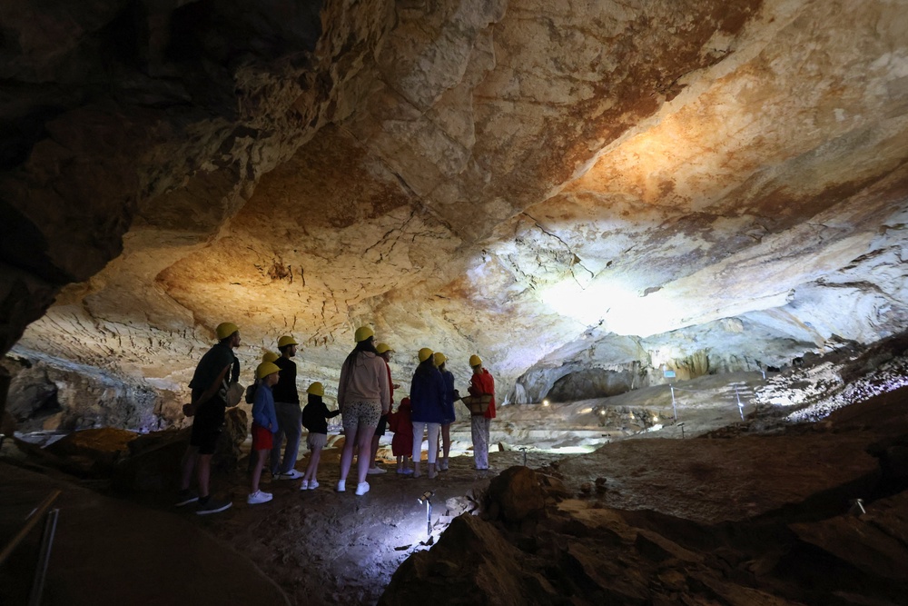 Tourists visit Vjetrenica Cave, a UNESCO World Heritage Site, where temperatures remain a constant 11 degrees to escape the summer heat (Reuters)