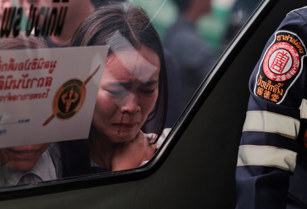 The relative of a victim reacts while looking at the victim's dead body (Reuters)