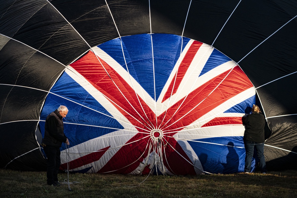 Crews check the crown of one patriotic hot air balloon (Ben Birchall/PA) (PA Wire)