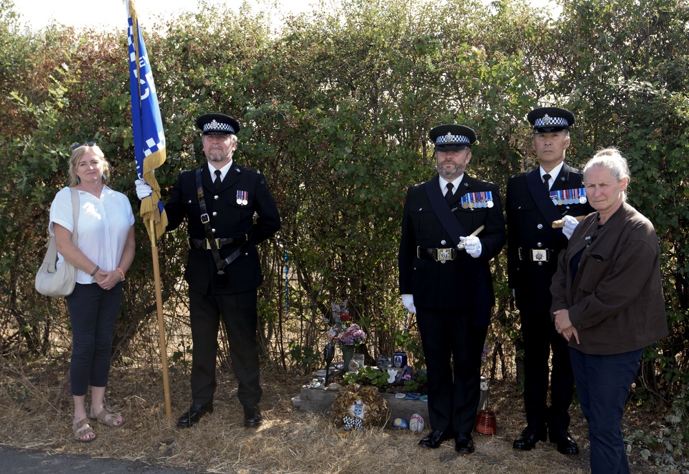 Police officers and Debbie Adlam, the mother of Pc Andrew Harper, paying their respects at the site near Sulhamstead, Berkshire, where the officer was killed (Martis Media/PA)