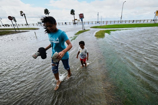 Kids play in the floodwaters from Tropical Storm Bertha in New Orleans, Louisiana, last month. The storm was one of two named storms in the Atlantic this year (AP)