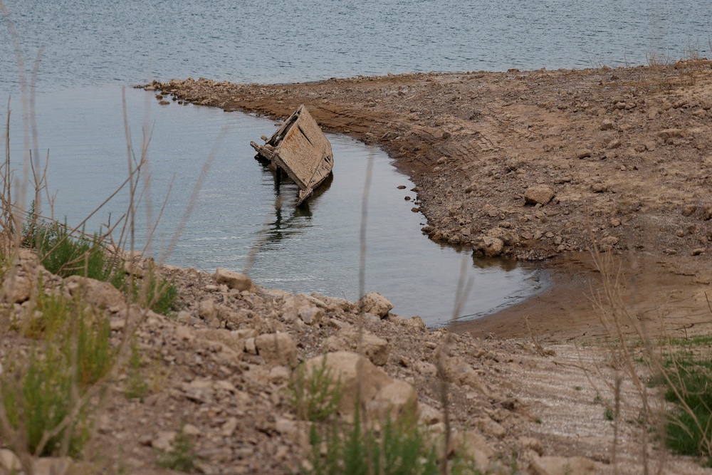 As water levels drop, the receding water exposes hidden shorelines, old rocks, land and objects that stayed underwater for decades (Reuters)