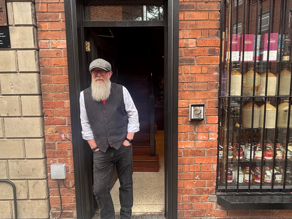 Jim Ingram, manager, of the Friend At Hand Irish whiskey shop in the Cathedral Quarter in Belfast on Saturday. (Rebecca Black/PA)