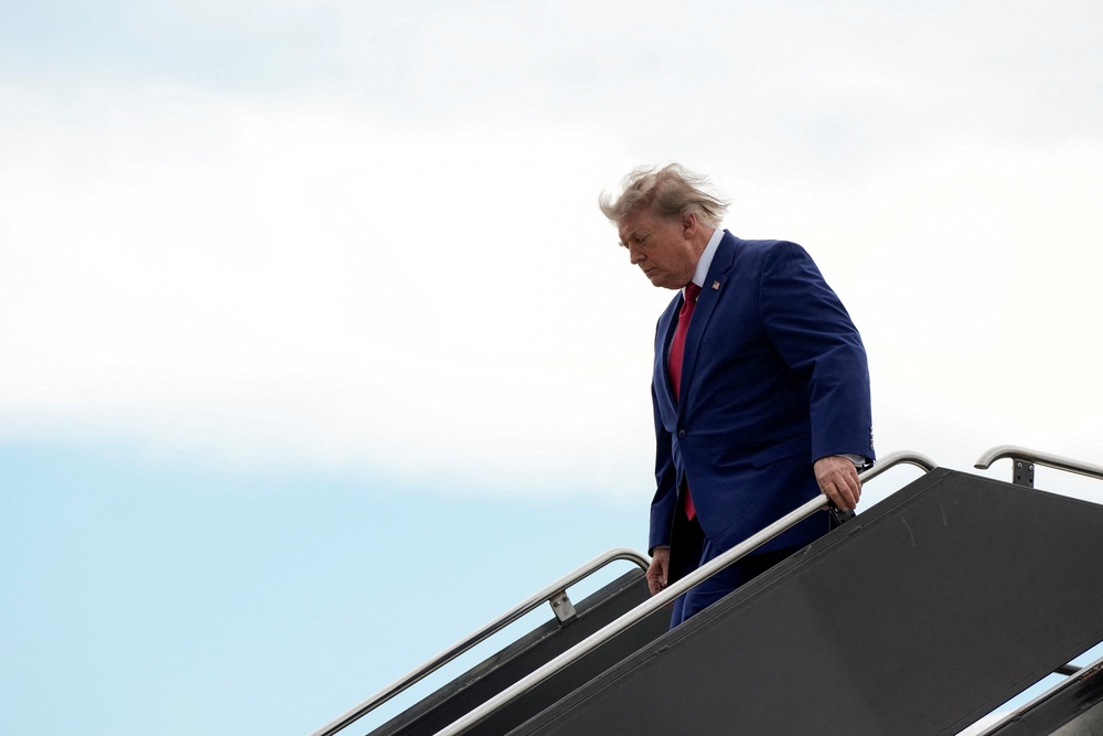 Donald Trump disembarks Air Force One in New Jersey on 7 August. The president continues to insist a deal is coming with Iran to reopen the Strait of Hormuz (Reuters)