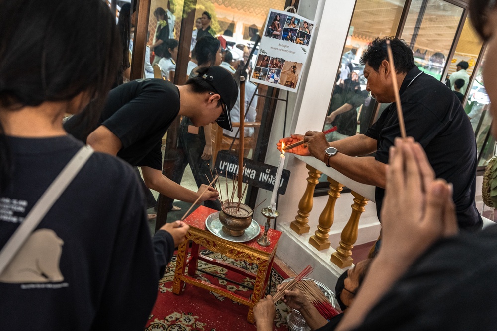 Mourners pray for 12-year-old school shooting victim Naphat Chaima at Wat Lat Pla Duk in Nonthaburi province (AFP/Getty)