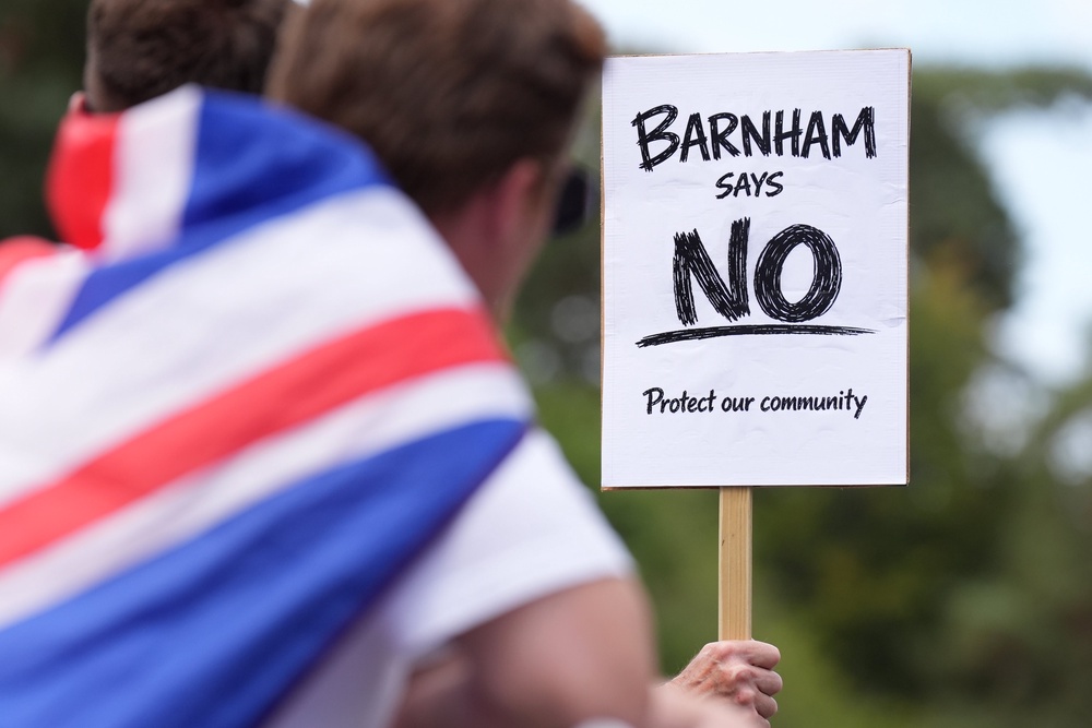 Demonstrators held placards outside the gates of the former RAF site (Joe Giddens/PA) (PA Wire)