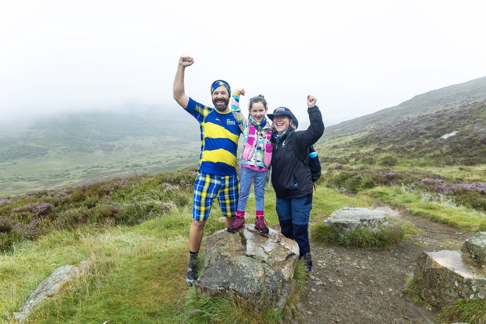Paul Choat with his daughter Skye and Nicola Roseman chief executive of My Name5 Doddie Foundation on Schiehallion (Graeme Hart/Perthshire Picture Agency/PA) (PA Media)