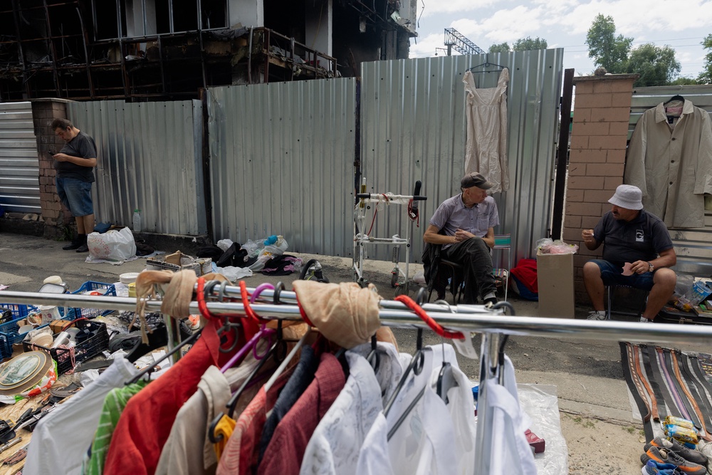 Vendors sit in front of their stalls at a damaged street market following strikes in Petrivka, one of Kyiv's neighborhoods (AFP/Getty)