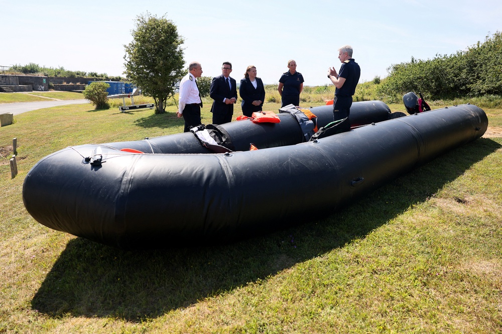Prime Minister Andy Burnham and Minister for Border Security and Asylum Anna Turley stand by a recovered small boat, used by migrants crossing the English Channel, as he meets with members of the Home Office and the Coastguard, during a visit to HM Coastguard Maritime Rescue Coordination Centre, in Dover, southern England,  on August 2, 2026. (AFP/Getty)
