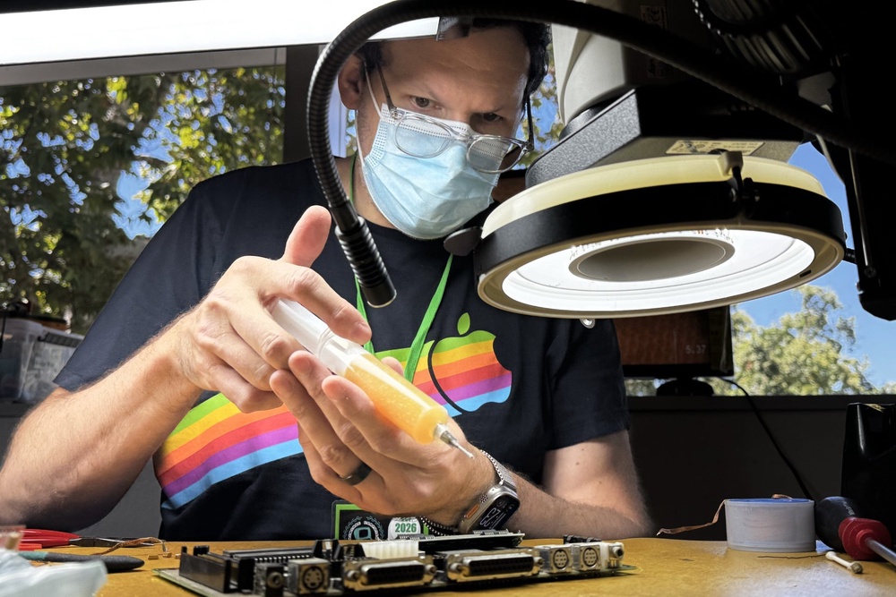 Arion Paylo repairs a circuit board at the Vintage Computer Festival in Mountain View, Calif., Sunday, Aug. 2, 2026 (AP Photo/Terry Chea)