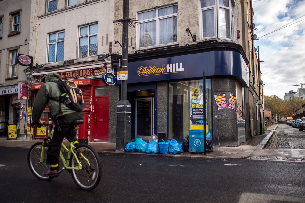 A man cycles past a William Hill bookmakers on Deptford High Street, London. Councils are set to have greater powers to reject new applications for bookmakers (Getty)