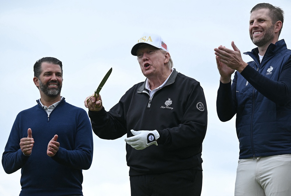 First sons Donald Trump Jr., left, and Eric Trump, right, are running their father’s company while he’s president (AFP/Getty)