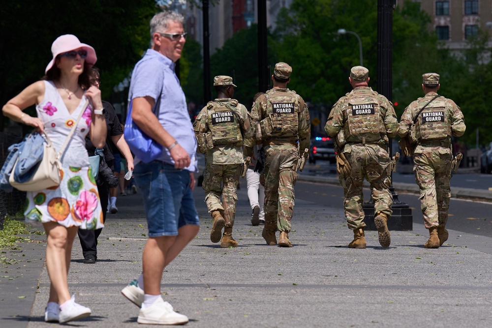 Members of the Florida National Guard pass by people on a sidewalk, April 17, 2026, in Washington (AP Photo/Jacquelyn Martin)