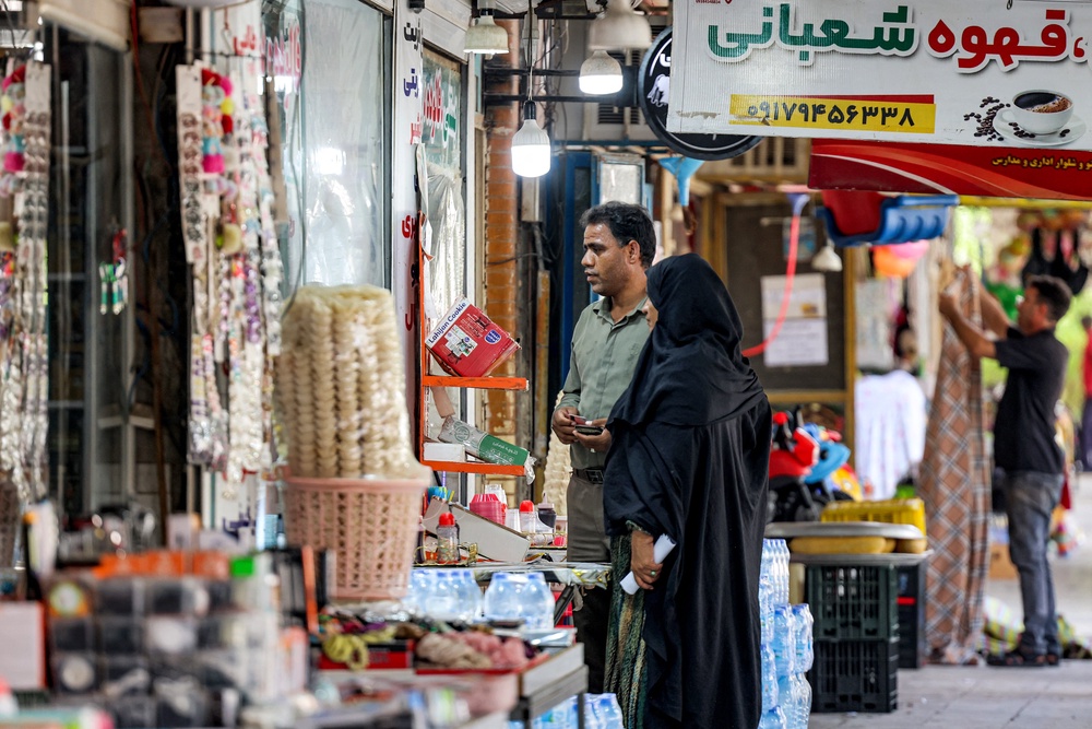 People shop at a market in Minab in Iran's southern Hormozgan province on August 10, (AFP/Getty)