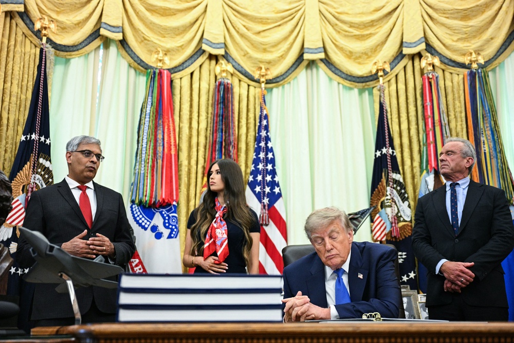 Director of the National Institutes of Health Jay Bhattacharya (L) speaks before President Donald Trump signs an executive order calling for more research and flexibility on vaccines (AFP via Getty Images)