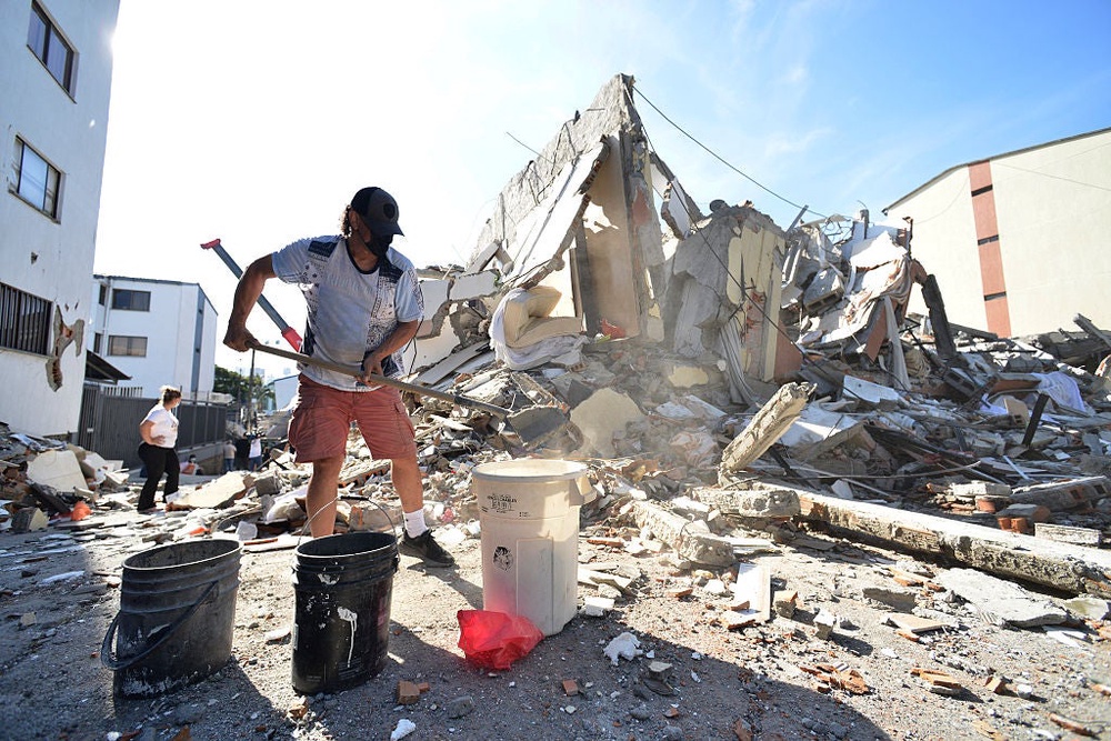 Rescue crews and local civilians worked painstakingly through heavy wreckage Tuesday (Getty Images)