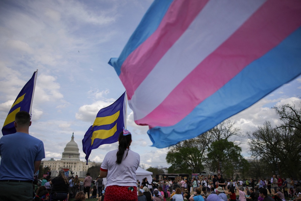 The Trump administration has implemented a government-wide effort targeting trans Americans, from limiting access to affirming healthcare coverage to seeking to remove them from the military (AFP/Getty)
