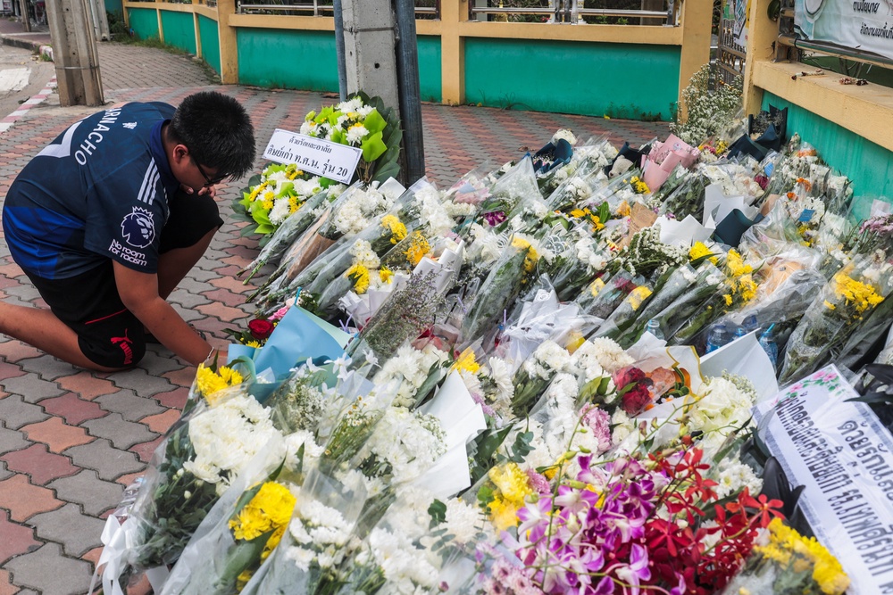 A student leaves flowers following a deadly shooting at the Debsirin Nonthaburi School on the outskirts of Bangkok (Reuters)