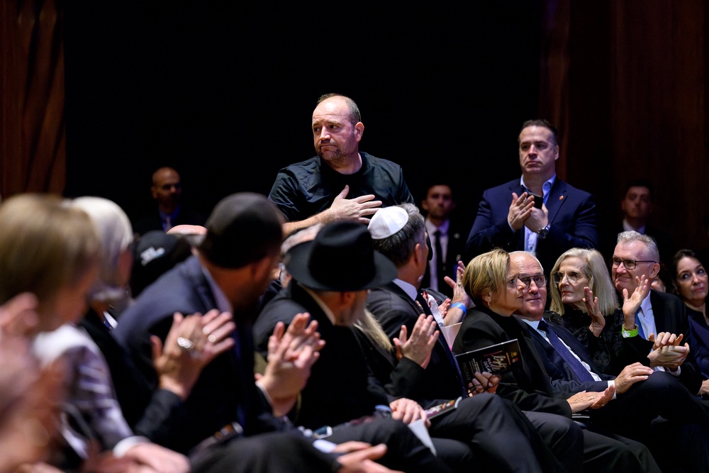 Ahmed al Ahmed, centre, gestures during the 'Light Will Win' memorial service, part of the day of mourning for the victims of the Bondi Beach shooting, at the Sydney Opera House on 22 January 2026 (AFP/Getty)