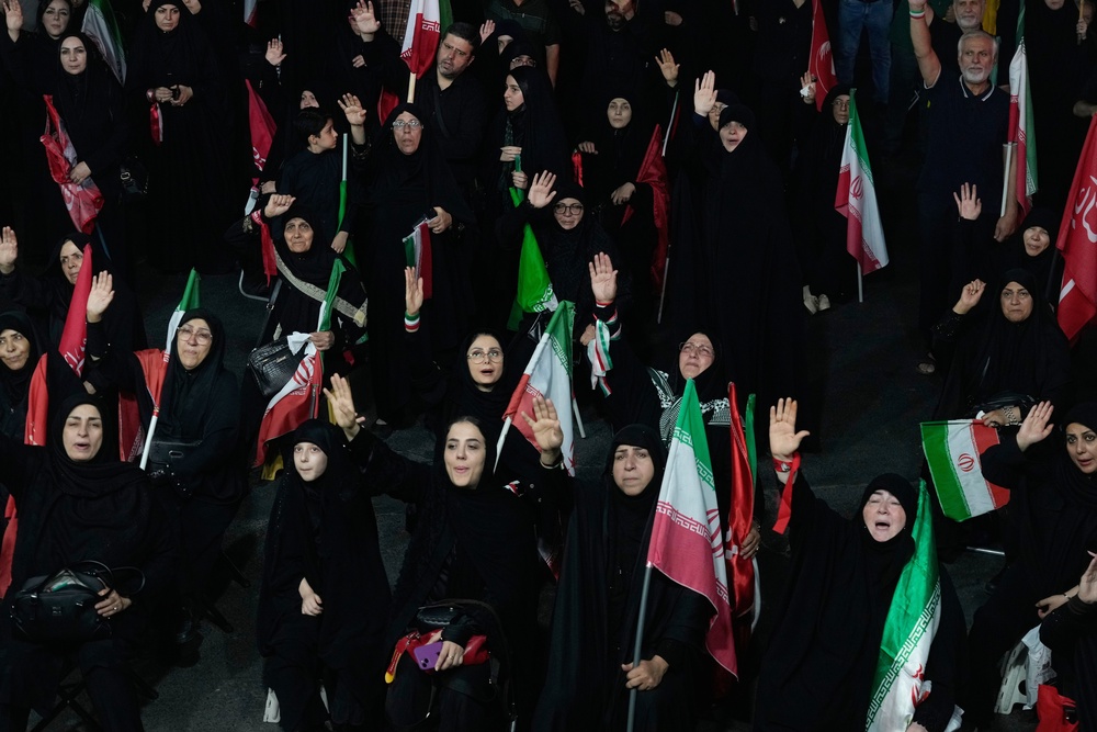 Iranian pro-government demonstrators attend a gathering at a square in Tehran (AP)
