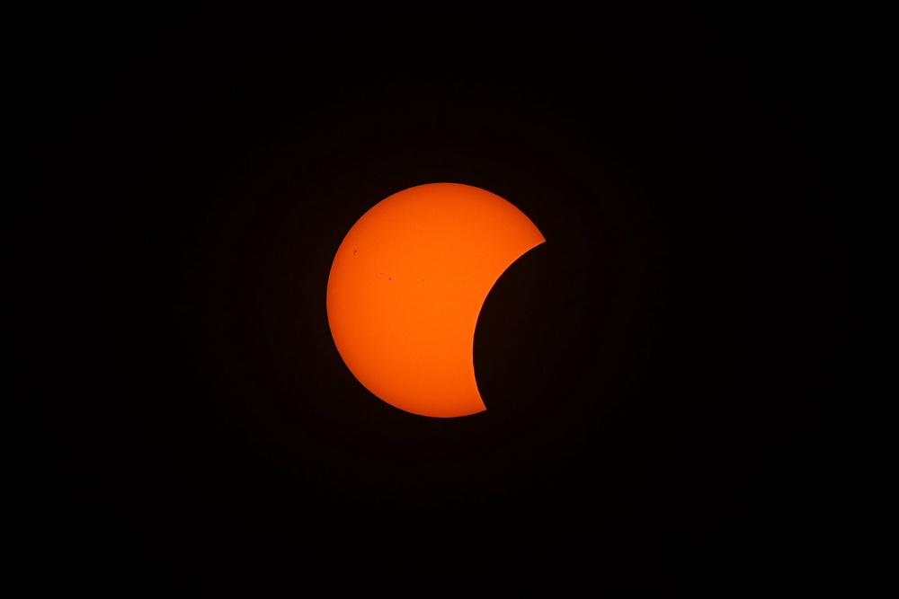 The Moon passes between the Earth and the Sun 6.38pm at the start of the solar eclipse as seen from King's Stairs Gardens in Bermondsey, south London (Aaron Chown/PA Wire)