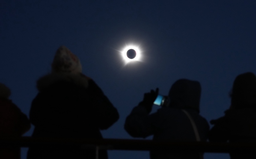 Cruise passengers take in the total eclipse from a cruise ship off the coast of Greenland (Owen Humphreys/PA Wire)