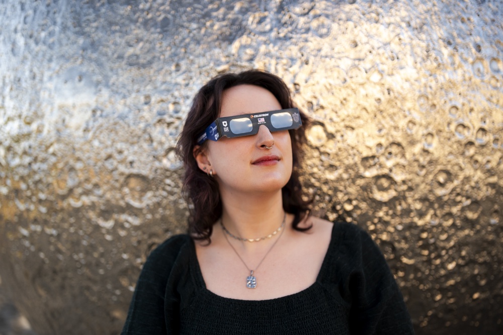 Planetarium Astronomer Dr Carys Herbert demonstrates wearing Celestron solar eclipse glasses (Jordan Pettitt/PA) (PA Wire)