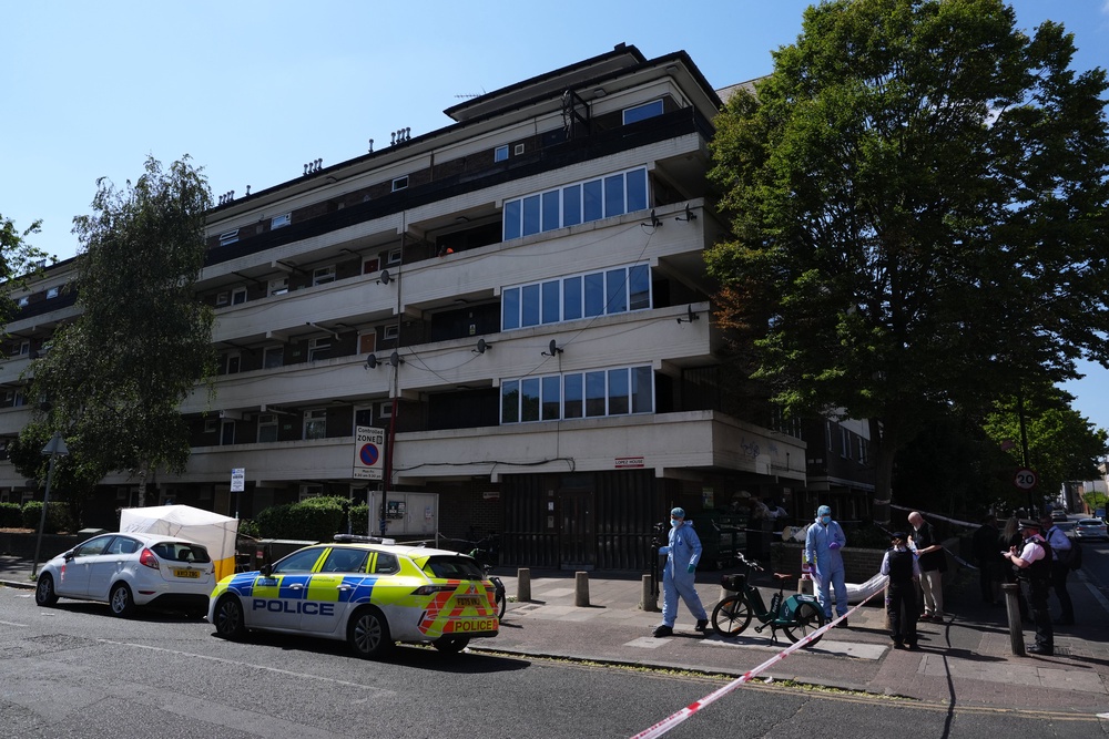 Officers in forensic suits at the scene outside Lopez House on Willington Road (Jonathan Brady/PA) (PA Wire)