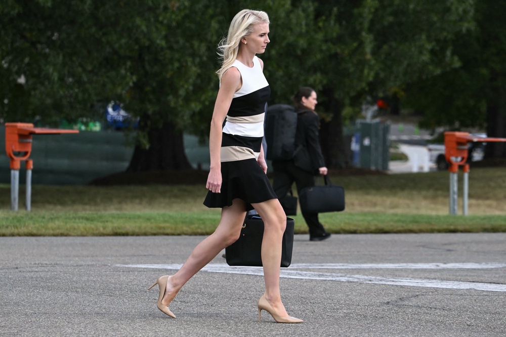 Natalie Harp, who rarely is far from President Trump, walks to the motorcade as he departs from Walter Reed National Military Medical Center after a medical checkup last year (AFP/Getty)