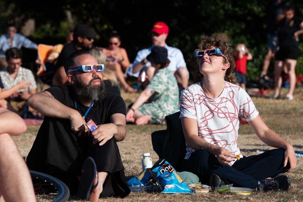Members of the public wear protective glasses while watching a partial solar eclipse (PA) (PA Wire)
