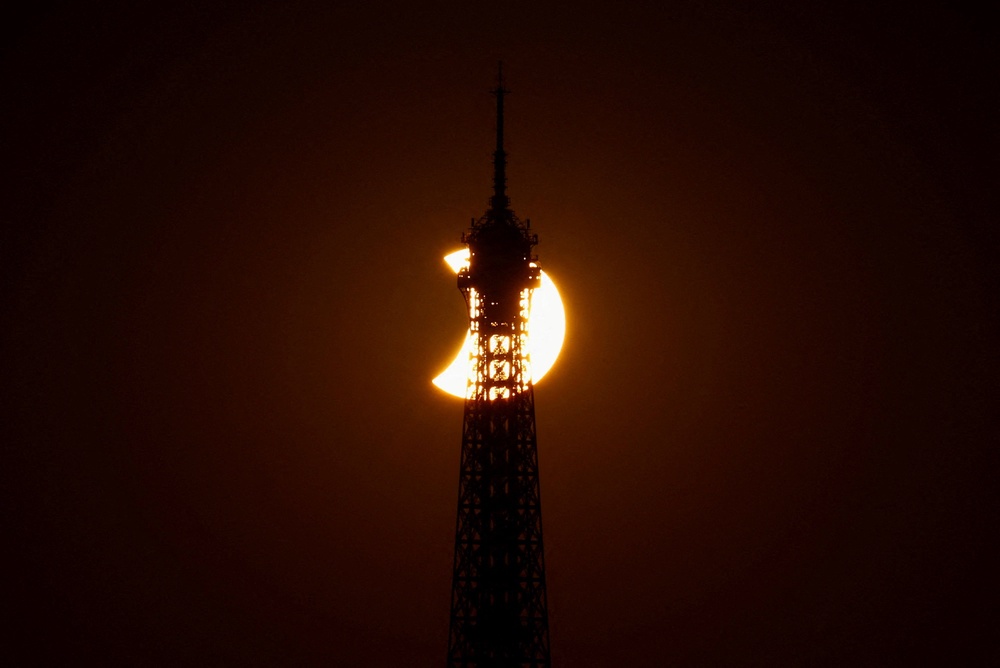 The Eiffel Tower is silhouetted as the moon partially covers the sun during a solar eclipse, as seen from Paris, France (Reuters)