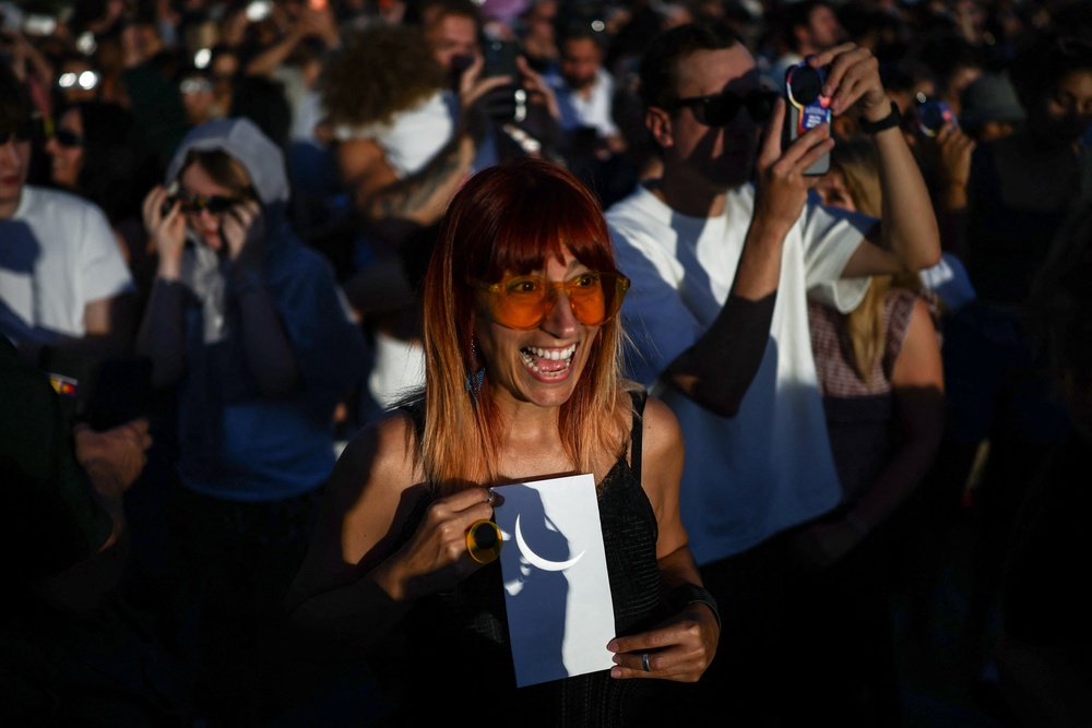 The eclipse was refracted from binoculars and seen on paper (AFP/Getty)