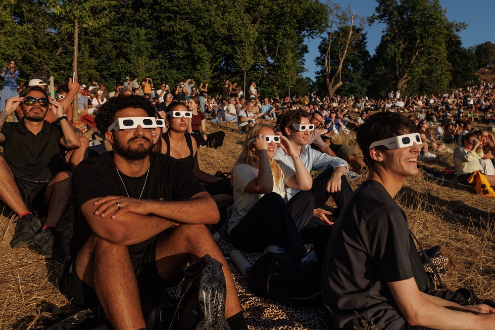 Greenwich Park, London, was full of people wearing special glasses to look up (Getty)