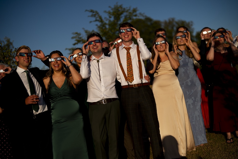 The wedding guests watch the solar eclipse at Alpheton in Suffolk (Jordan Pettitt/PA) (PA Wire)