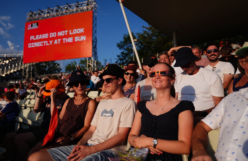 Spectators in the stands uses special eclipse glasses to watch the solar eclipse (Jacob King/PA) (PA Wire)