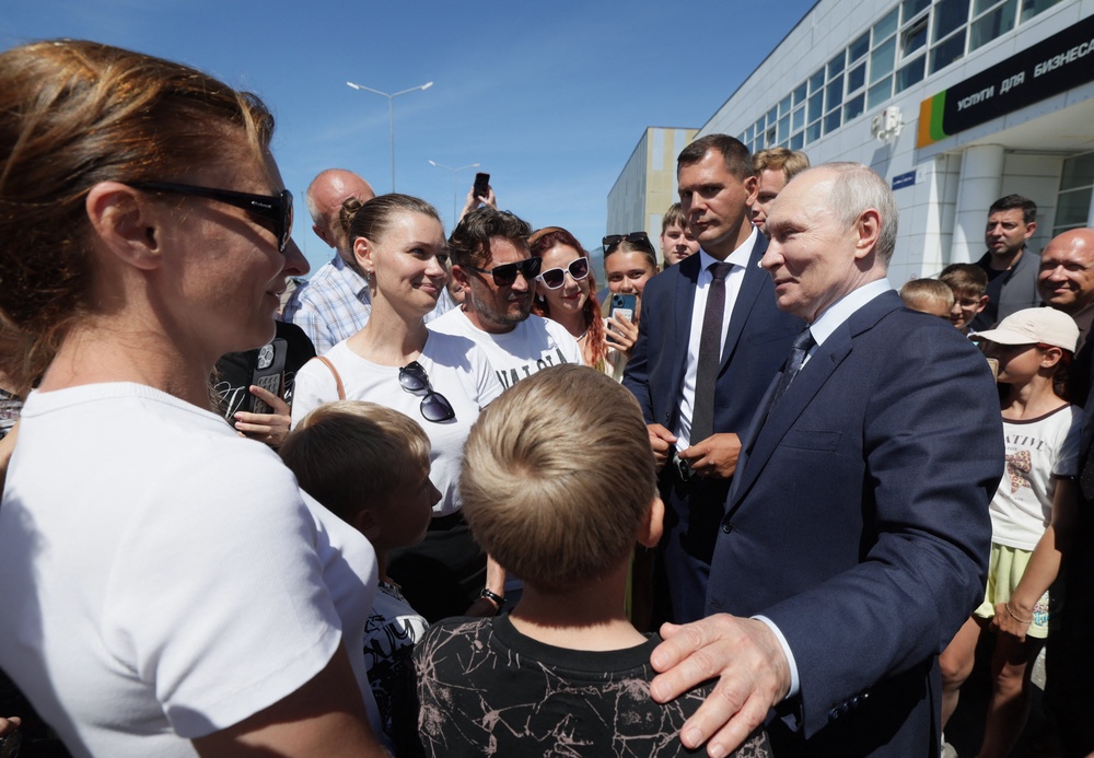 Vladimir Putin interacts with local residents on Iturup island, one of four islands in the contested chain known as the Kuril Islands in Russia and the Northern Territories in Japan (Sputnik)