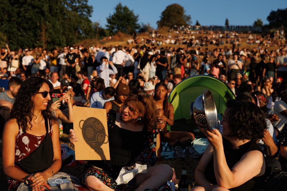 People gather to view the partial solar eclipse in Greenwich Park (Getty)