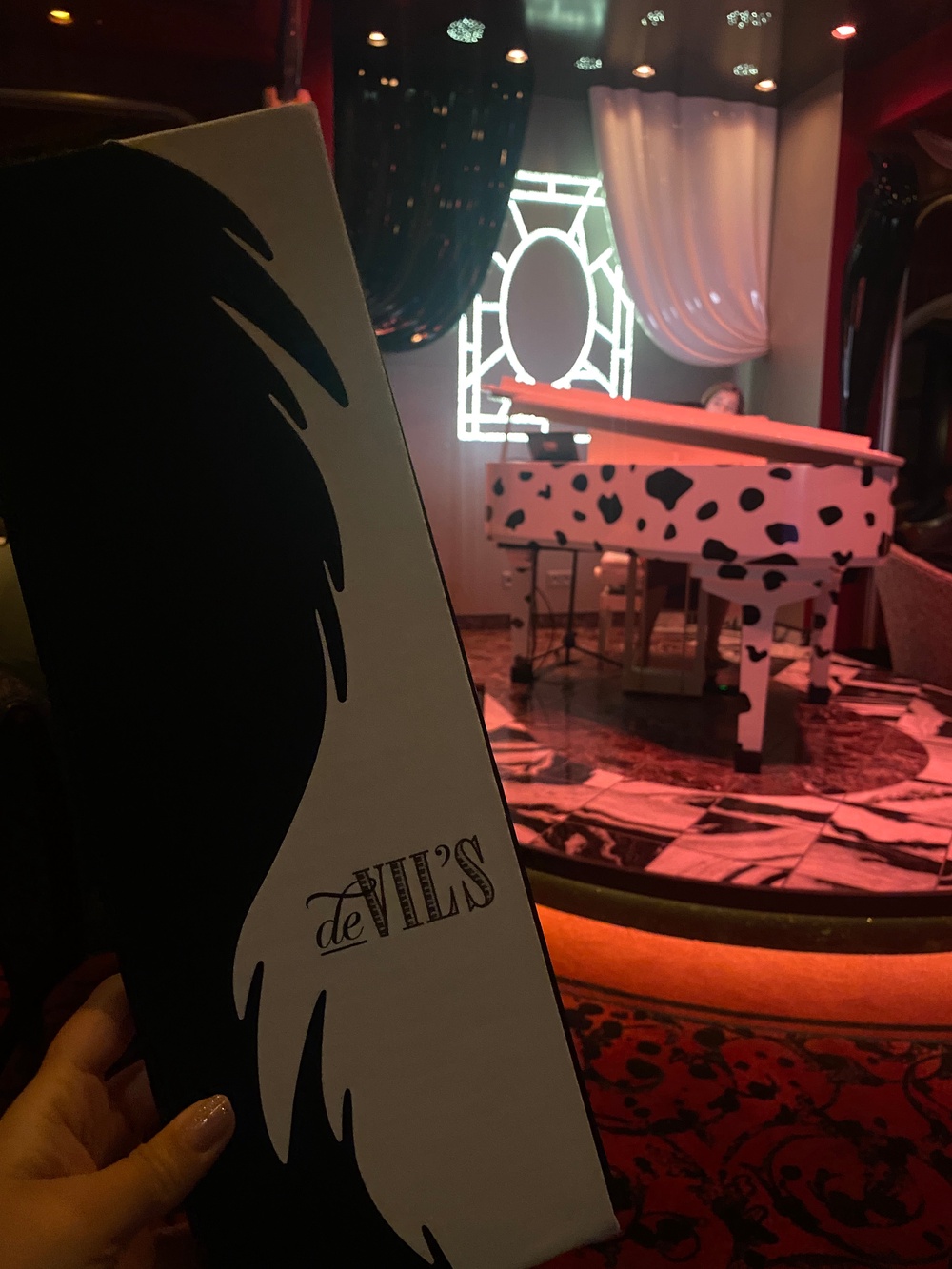 Nearly every detail in De Vil’s references ‘101 Dalmatians,’ from the monochrome décor and spotted piano to themed cocktails and playful touches throughout the room (Caitlin Hornik / The Independent)