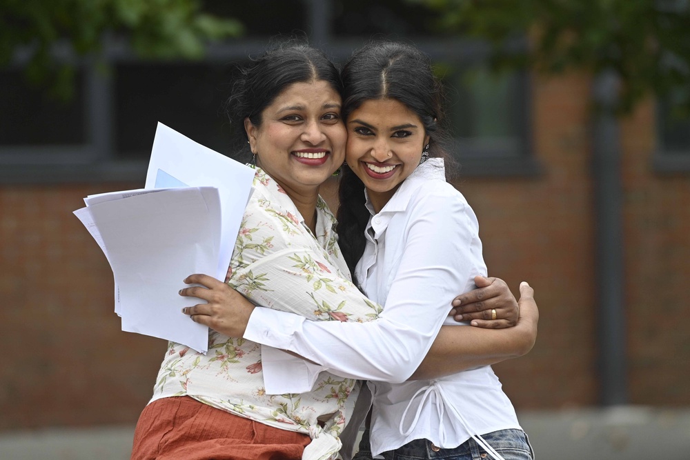 Student Allet Rosh celebrates her A-level results with her mother Shiji Paul at Our Lady and St Patricks College Knock in Belfast (Mark Marlow/PA) (PA Wire)