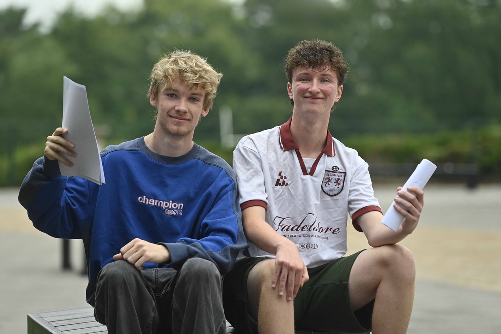 Students Christopher Ritchie and Malachy Price celebrate their A-level results at Our Lady and St Patricks College Knock in Belfast (Mark Marlow/PA) (PA Wire)