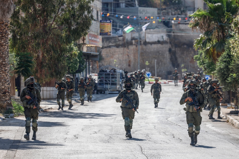 Israeli soldiers have been deployed to Qusra after settlers laid siege to Palestinian residents for several days (AFP/Getty)