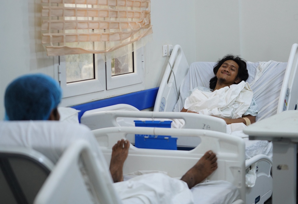 Indonesian crew member Muhammad Al Taindo , right, receives medical treatment  after the cargo ship Tihama was struck in a Houthi attack in the Bab al-Mandab Strait (AP)