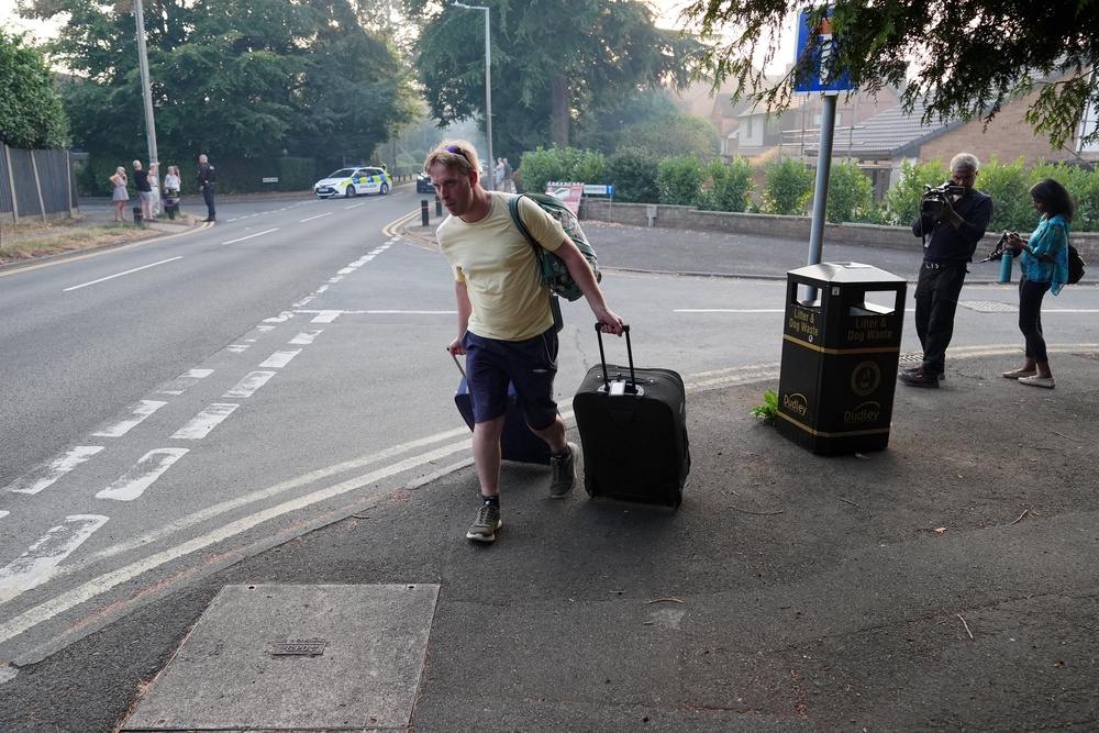 A resident leaves their home after a fire broke out in the Stourbridge area (PA)