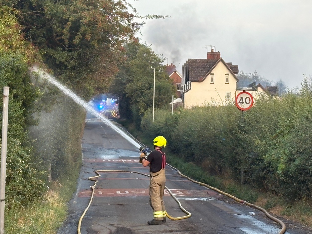 Fire crews working on Racecourse Lane, Stourbridge, where properties have been damaged by the fire (PA)