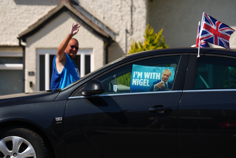 A car with a Reform UK leader Nigel Farage poster in Little Clacton (Joe Giddens/PA) (PA Wire)