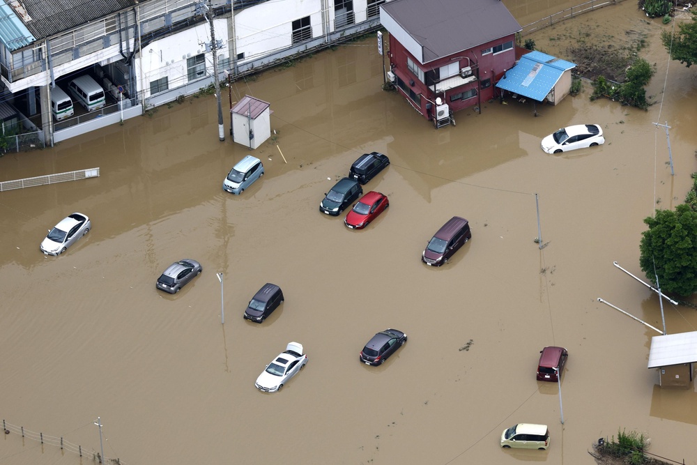 Submerged cars after heavy rain in Oamishirasato (Kyodo News)